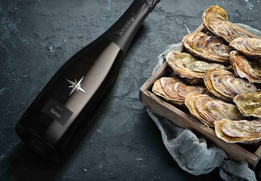 Fresh closed oysters. Seafood On a black stone background. Top view. Free copy space.